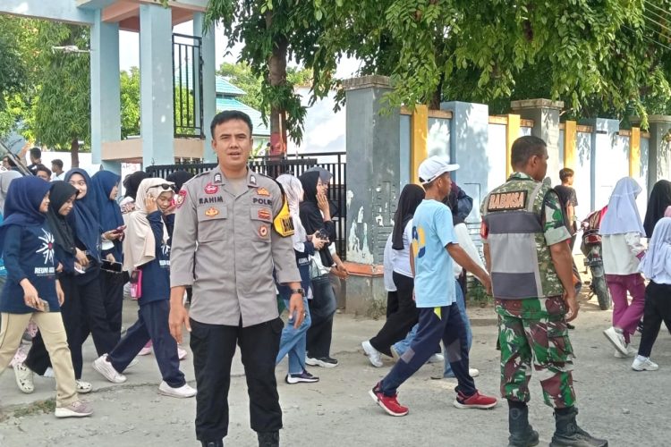Pastikan Rasa Aman, Bhabinkamtibmas Polsek Banggae Kawal Jalan Santai Reuni Akbar SMKN 5 Majene
